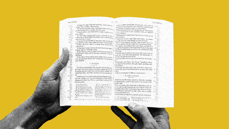 person holding open Bible